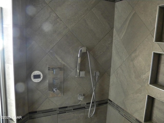 bathroom with a tile shower