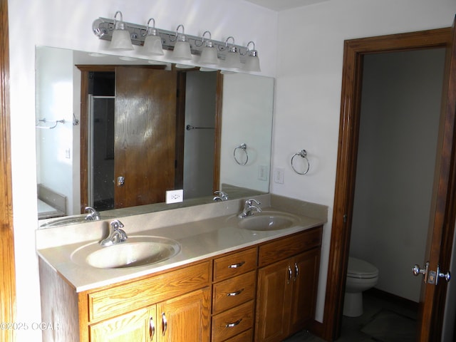 bathroom featuring toilet and vanity