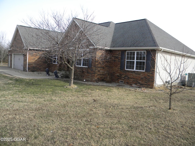 view of front of home with a garage and a front lawn