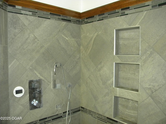 interior details featuring a tile shower