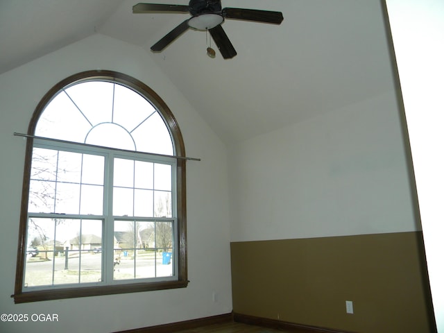 empty room with ceiling fan and lofted ceiling