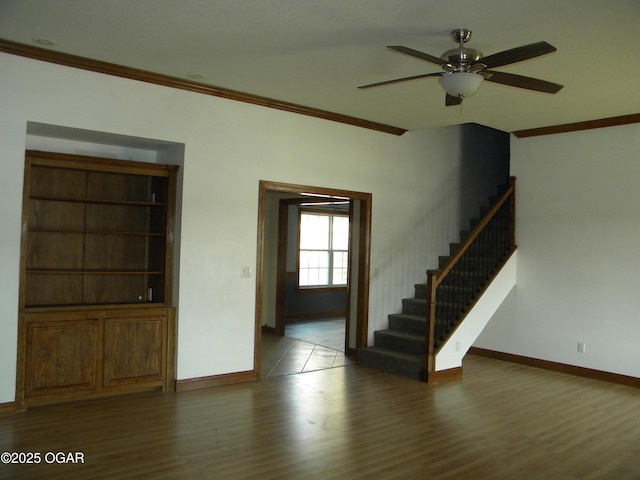 spare room featuring ceiling fan, wood-type flooring, and crown molding