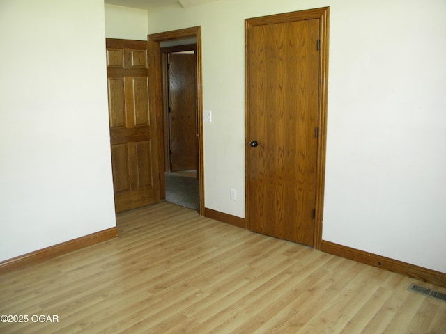 spare room featuring light hardwood / wood-style flooring