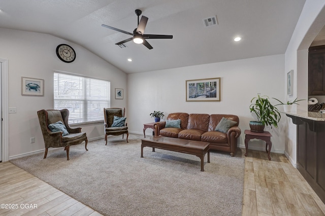 living room with lofted ceiling, light wood-type flooring, and ceiling fan