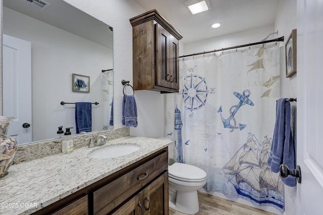 bathroom with toilet, wood-type flooring, and vanity