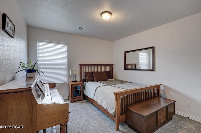 carpeted bedroom featuring a textured ceiling