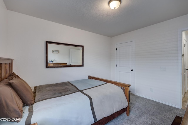 bedroom featuring carpet floors and a textured ceiling