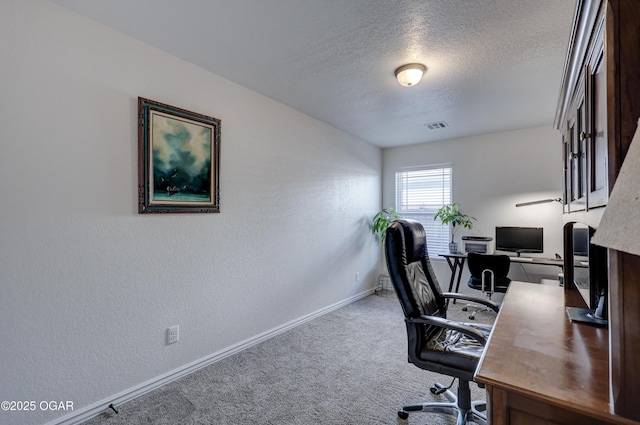 office featuring carpet floors and a textured ceiling