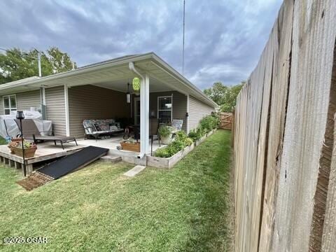 rear view of property featuring a yard and a deck