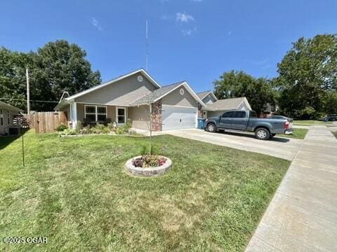 view of front of home featuring a front lawn and a garage