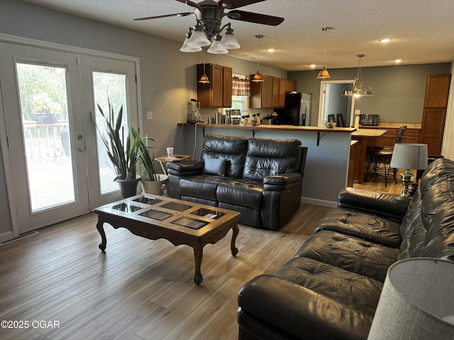 1019 Hawthorne St, Carthage, MO 64836 - living room with a ceiling fan, light wood finished floors, a textured ceiling, and recessed lighting