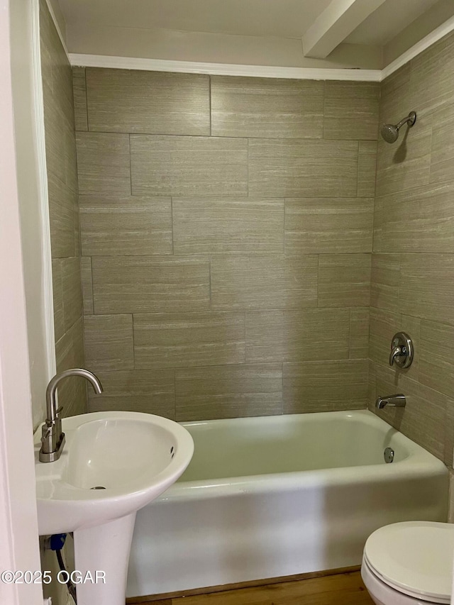 full bathroom featuring shower / washtub combination, a sink, and toilet