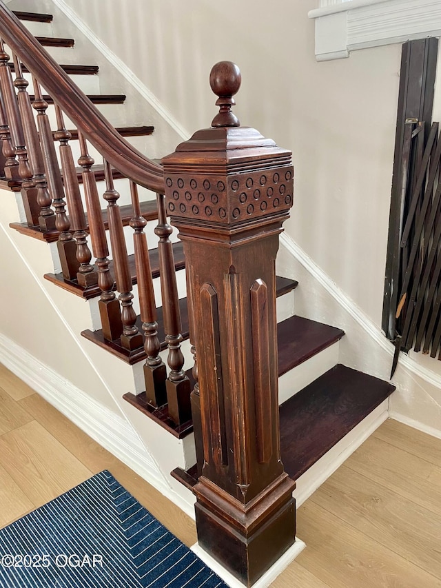 stairs with baseboards and wood finished floors