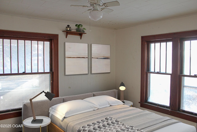 bedroom featuring ceiling fan and ornamental molding