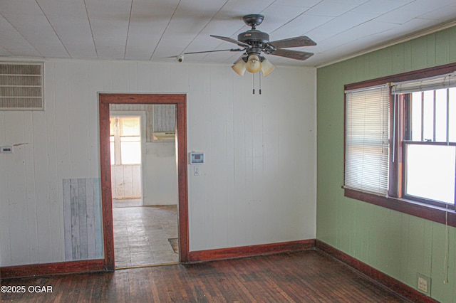 spare room with wood walls and dark wood-type flooring