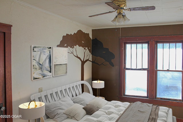 bedroom with ceiling fan and crown molding