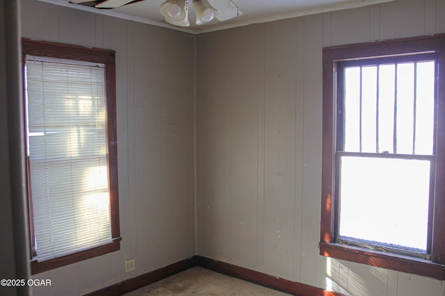 spare room featuring ceiling fan and crown molding