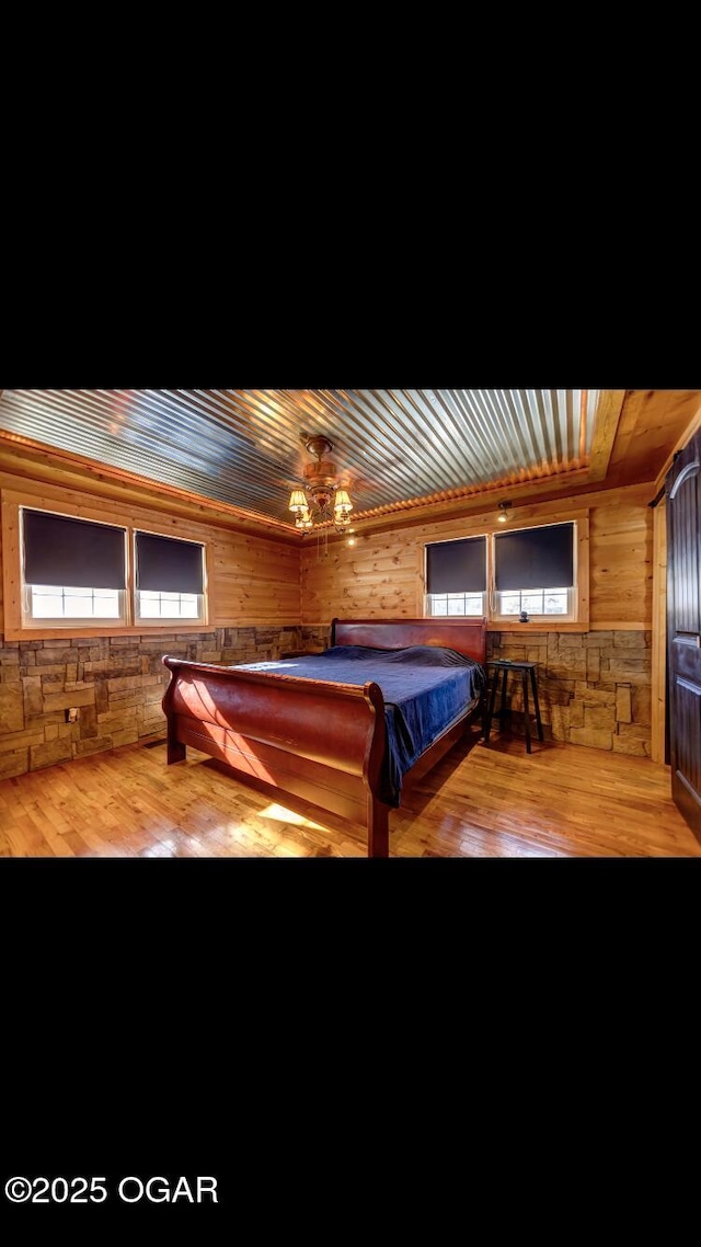 unfurnished bedroom featuring multiple windows, billiards, light wood-type flooring, and wood ceiling