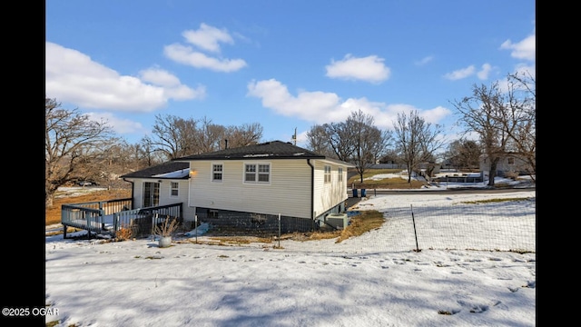 view of snow covered exterior featuring a deck