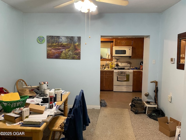 kitchen featuring ceiling fan, light colored carpet, and white appliances