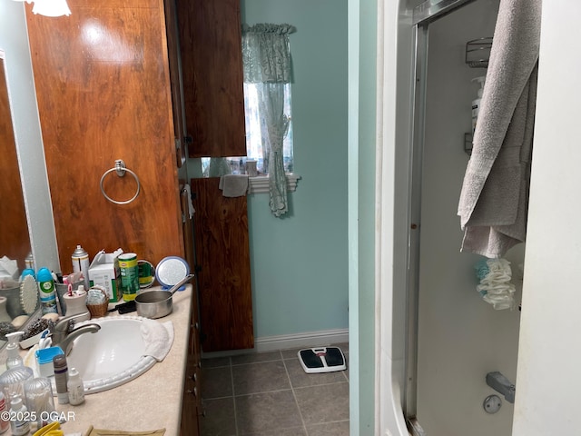 bathroom with tile patterned floors, vanity, and walk in shower