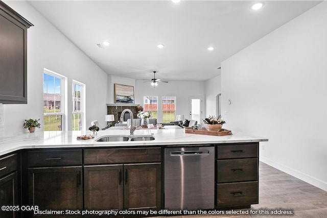 kitchen with dishwasher, light hardwood / wood-style floors, kitchen peninsula, and sink