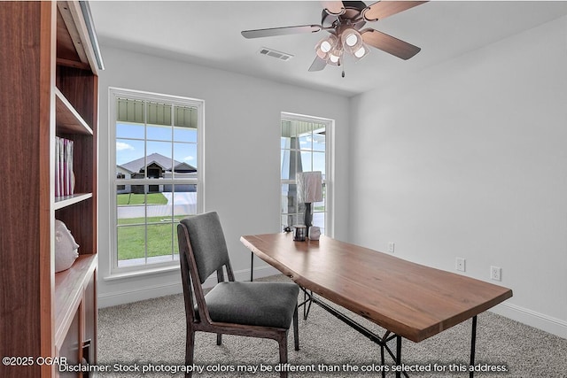 office space with light carpet and ceiling fan