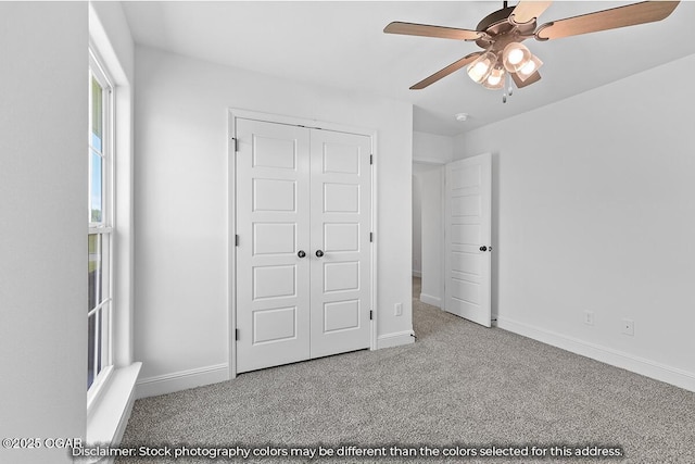 unfurnished bedroom featuring ceiling fan, light carpet, and a closet