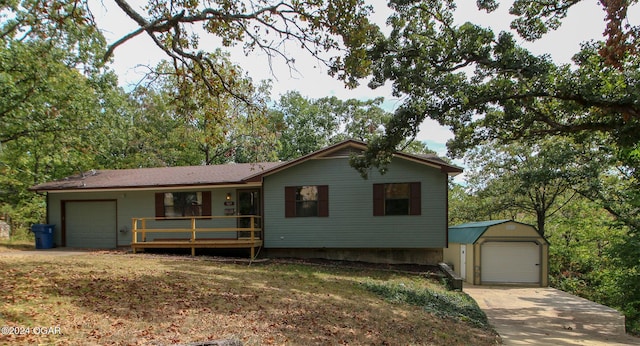 ranch-style house with a garage and an outbuilding