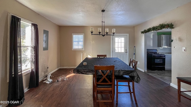 dining area with electric panel, an inviting chandelier, a textured ceiling, and dark hardwood / wood-style floors