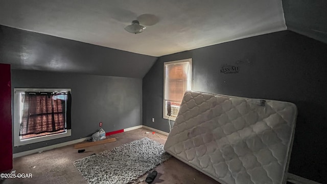 bedroom featuring multiple windows and lofted ceiling