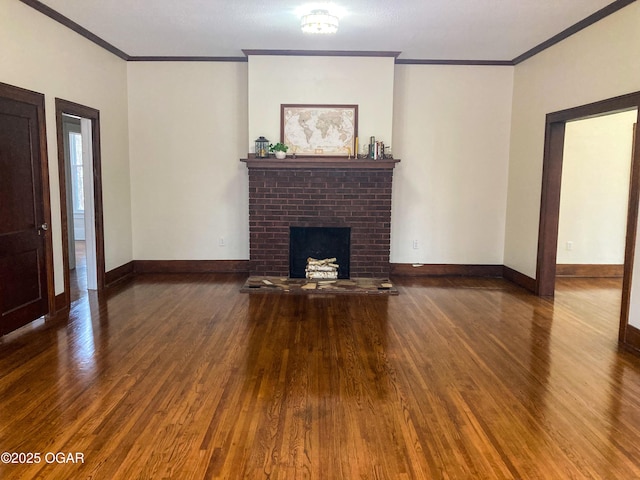 unfurnished living room with dark wood-type flooring, crown molding, and a brick fireplace