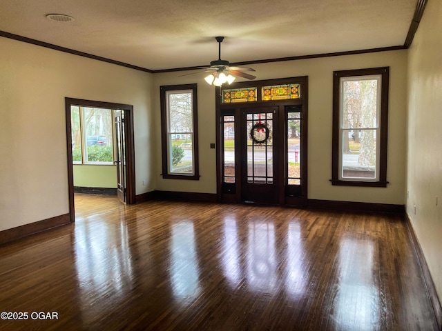 entrance foyer with ceiling fan, wood-type flooring, and crown molding