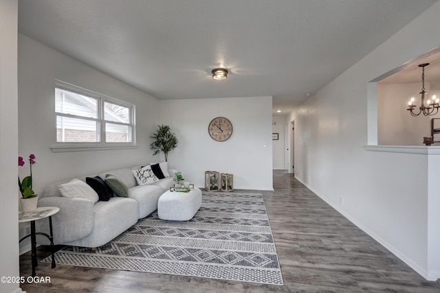 living room with an inviting chandelier and hardwood / wood-style floors