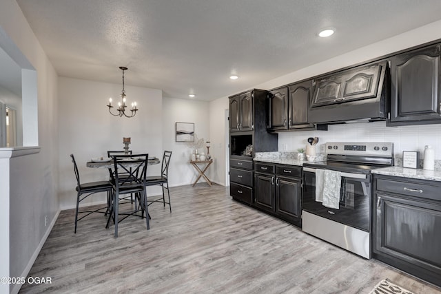 kitchen with decorative backsplash, pendant lighting, electric range, and light hardwood / wood-style flooring