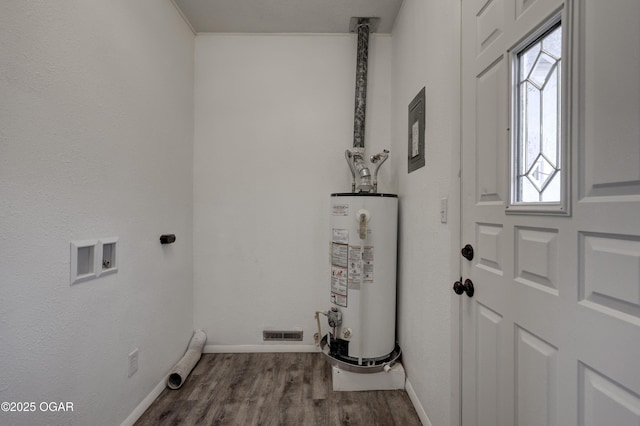 washroom with electric dryer hookup, hardwood / wood-style floors, hookup for a washing machine, and gas water heater