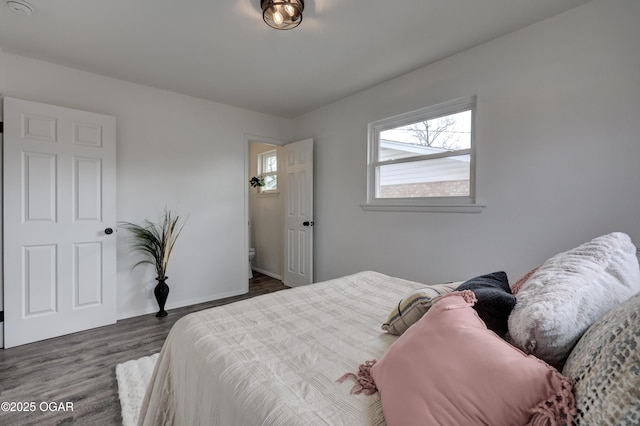 bedroom with dark hardwood / wood-style floors