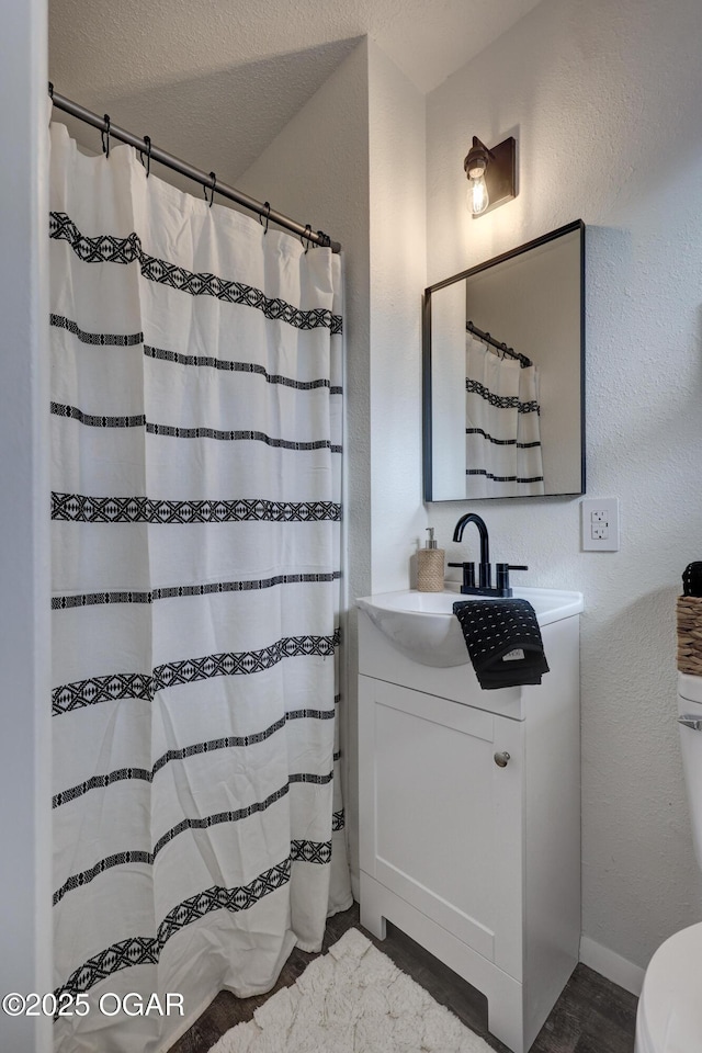 bathroom with vanity, a textured ceiling, and a shower with shower curtain