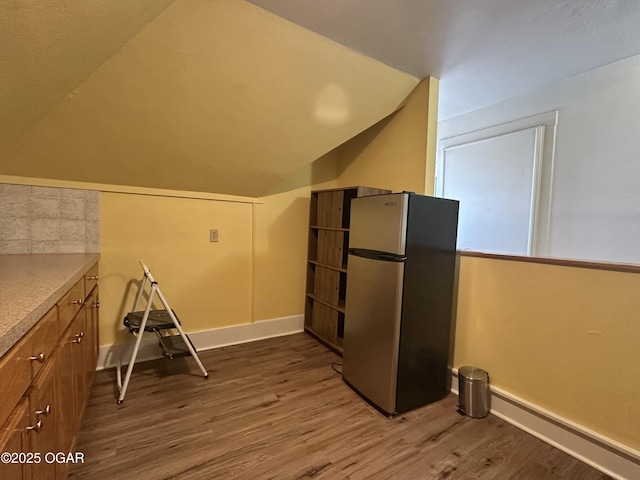 bonus room featuring lofted ceiling and wood-type flooring