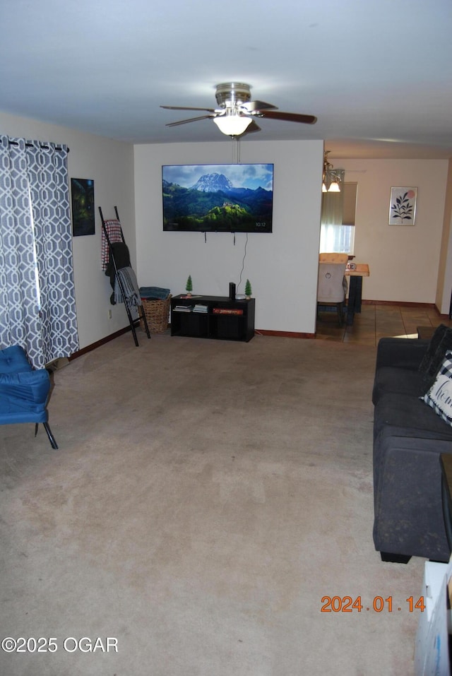 carpeted living room featuring ceiling fan