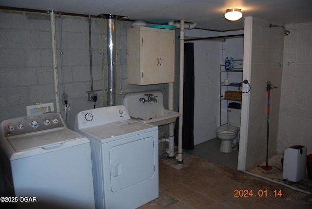 washroom with washer and clothes dryer and sink