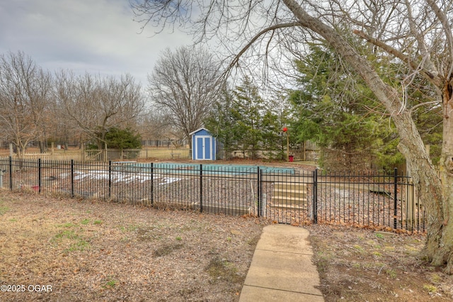 view of yard with a community pool and a storage shed