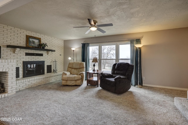 carpeted living room featuring ceiling fan, a brick fireplace, and a textured ceiling