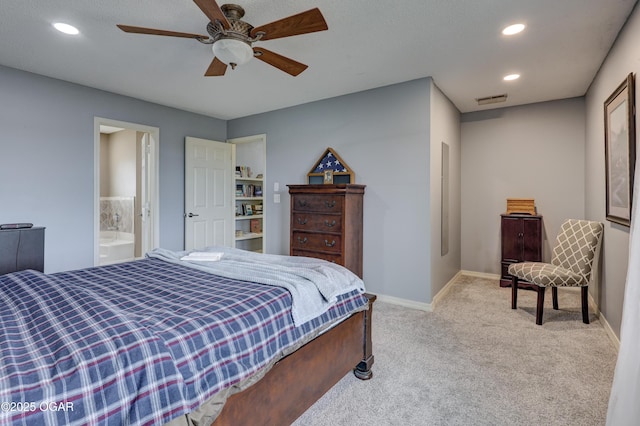 carpeted bedroom with ceiling fan and ensuite bathroom