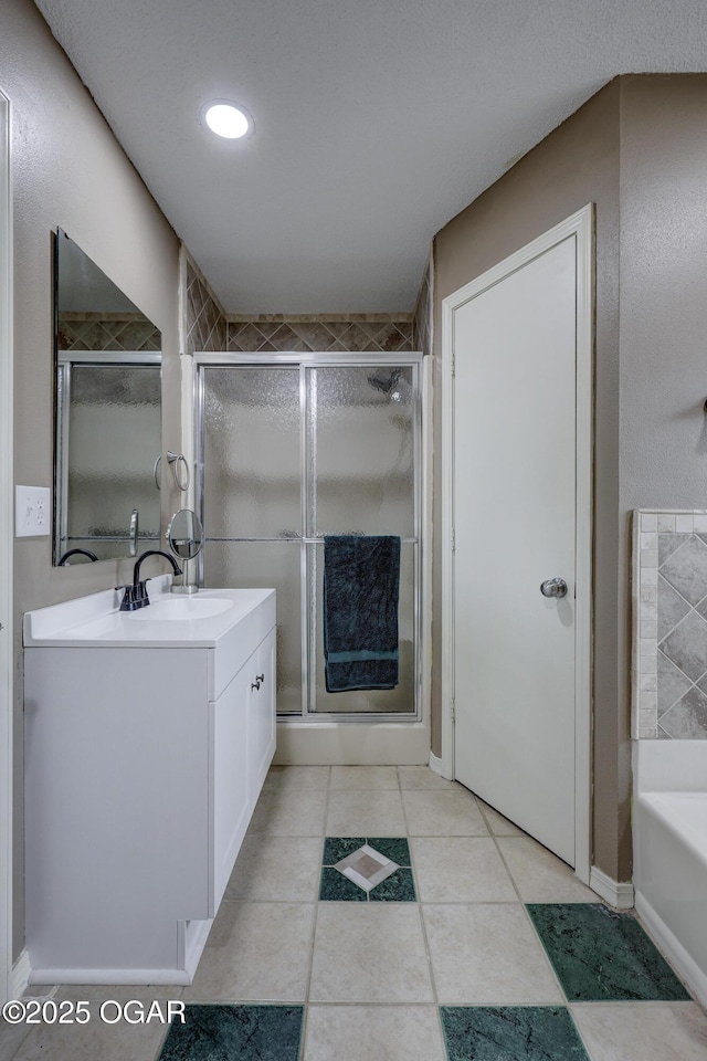 bathroom featuring vanity, independent shower and bath, and tile patterned flooring