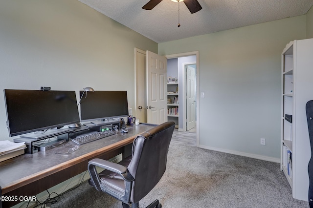 carpeted home office featuring ceiling fan and a textured ceiling