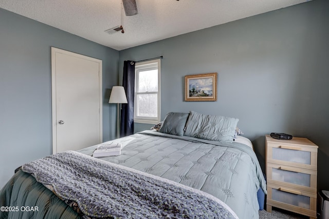 bedroom featuring ceiling fan and a textured ceiling