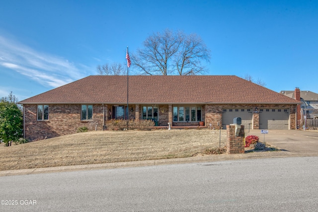 ranch-style home with a front yard and a garage