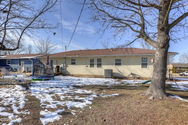 snow covered property featuring a trampoline