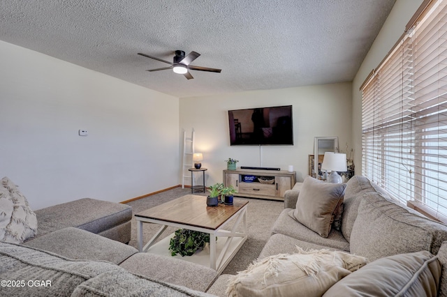 living room featuring a textured ceiling, ceiling fan, and carpet floors